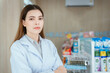 © 2B - A female pharmacist looking at the camera in a pharmacy