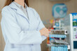 © 2B - A female pharmacist looking at the camera in a pharmacy