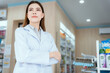 © 2B - A female pharmacist looking at the camera in a pharmacy