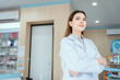 © 2B - A female pharmacist looking at the camera in a pharmacy
