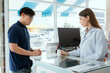 © 2B - Pharmacist Chayong standing and talking to the patient Buying medicines with a credit card online spending