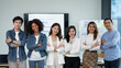 © amnaj - Young businessman and a beautiful Asian businesswoman stand with her arms crossed and pose for a beautiful team photo in the company.