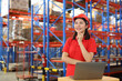 © feeling lucky - Portrait of warehouse workers young asian woman standing and using computer while looking away while controlling stock and inventory in retail warehouse logistics, distribution center