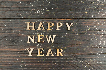 Happy New Year Letters on wooden postcard on wooden background.c opyspace for text