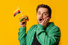 Surprised Man With Burger And German Flag On Yellow Background