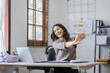 © David - Asian indian women are stressed while working on laptop, Tired asian businesswoman with headache at office, feeling sick at work copy space in workplace an home office.