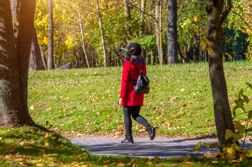 Wall Mural - Girl walks in the city autumn Park
