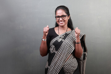 Wall Mural - Happy woman of Indian ethnicity  with an excited face and cheering gesture