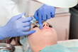 © Vera - Lip augmentation. Beautician injects hyaluronic acid into the lips of a girl with a syringe. The cosmetologist doctor performs the procedure in the cosmetology office. Plastic surgery.