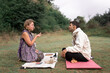 © ADDICTIVE STOCK - Tranquil woman and man preparing for shamanic healing procedure in nature