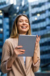 © NDABCREATIVITY - Portrait of successful woman using digital tablet in urban background. Business people concept