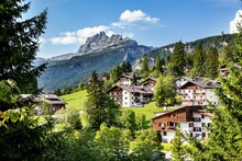 Scenic View Of Cortina D'Ampezzo Dolomites Town On Ahill Wit Green Trees And Mountainous Landscape