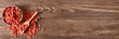 © Pixel-Shot - Bowl and scoop with dried goji berries on wooden background with space for text, top view