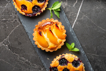 Wall Mural - Fresh-made gourmet Blueberry and Apricot Frangipane Tarts