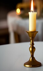 Sticker - Vertical shot of a burning candle on a bronze candle holder on a table