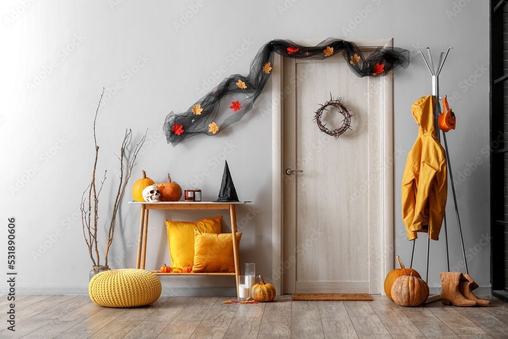 Interior of hall decorated for Halloween with table and rack