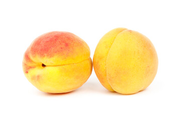 Two ripe peaches on a white background, close-up.