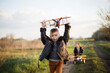 Chłopcy spełniają marzenie o lataniu, biegną drogą z samolotem w ręce