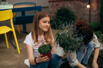 Wall Mural - mother and daughter gardening plants in home backyard