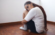 Depression, stress and anxiety with a woman suffering with her mental health while sitting on the floor alone. Sad, fear and suicide with a young female thinking and feeling pain, angry or grief
