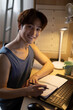 © Blue Jean Images - Young university student using laptop in dormitory