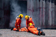 Group firefighters men wearing firefighting suit on safety rescue duty help stop breathing heart attack man inside burning  emergency CPR. safety accident protection safety concept.