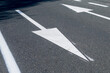 freshly painted directional arrows on a road