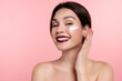 © deniskomarov - Beautiful woman  applying daily face moisturizer , smiling girl use moisturizing cream enjoy healthy skin on pink studio background.
