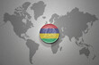 euro coin with national flag of mauritius on the gray world map background.3d illustration.