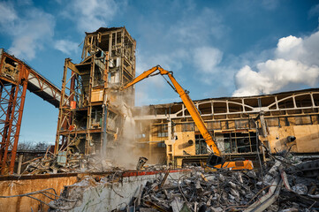 Destroyer excavator with large manipulator near factory