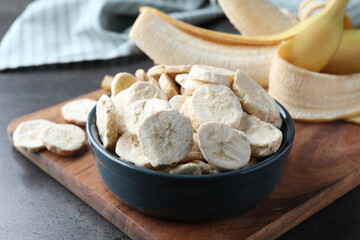 Freeze dried and fresh bananas on grey table, closeup