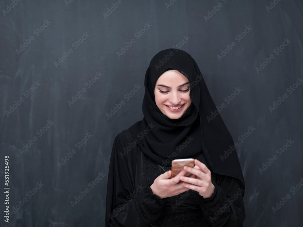 Young modern muslim business woman using smartphone wearing hijab ...
