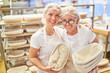 © Robert Kneschke - Successful bakery team with apprentice and baker