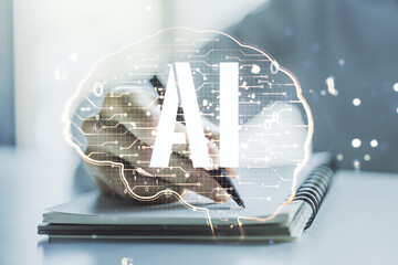 Wall Mural - creative artificial intelligence concept with human brain sketch and man hand writing in diary on ba