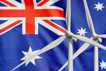 Wall Mural - Two Wind Turbines for alternative energy on Australia flag background. Energy development and energy crisis. Eco power and Wind stations for renewable electric energy production in Australia