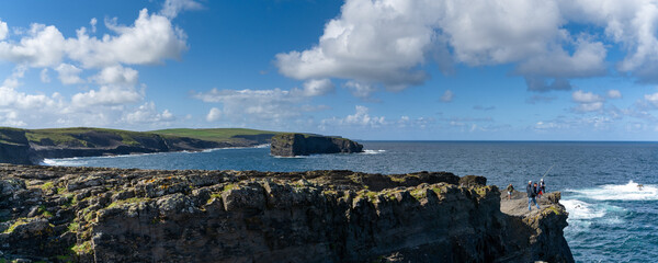 Sticker - panorama landscape of the wild Kilkee Cliffs with daring fishermen on the cliff edge