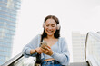 © Drobot Dean - Young beautiful asian smiling happy girl in headphones with phone