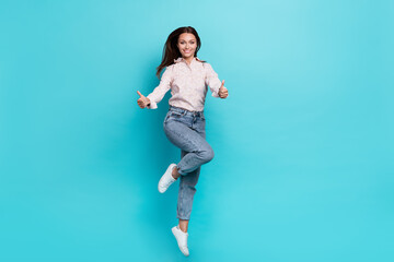 Canvas Print - Photo of satisfied girl two arm demonstrate like cool symbol rejoice stylish outfit empty space isolated on aquamarine color background