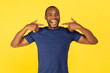 © Prostock-studio - Black Guy Pointing Fingers At Toothy Smile Over Yellow Background