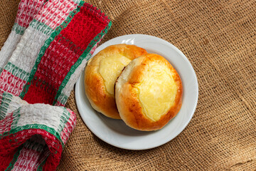 two buns with cottage cheese in a white plate