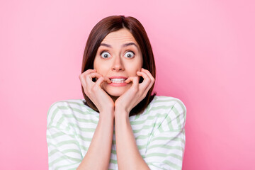 Canvas Print - Photo portrait of nice young girl afraid terrible news staring bite nails dressed stylish striped garment isolated on pink color background