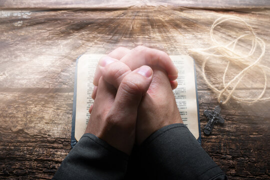 man praying on the Bible selective focus