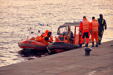 Water Lifeguards On The Pier. Motor Boats With Rescuers Moored To The Shore. Rescue Inflatable Boats On The Water.