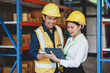 © amnaj - Two Asian warehouse workers check and count inventory accurately and tidy with their tablet computer.