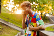 Young handsome smiling happy man in colorful shirt talking phone