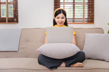 Asian woman working at home on the sofa business woman Business document check, account audit, document search, document preparation, report, analysis, tax, time, accounting, data sheet