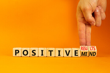 Positive results and mind symbol. Concept words Positive results or Positive mind on wooden cubes. Businessman hand. Beautiful orange background. Business positive results and mind concept. Copy space