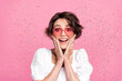 Photo of funny impressed girl dressed white top heart eyewear arms cheeks getting surprise isolated pink color background