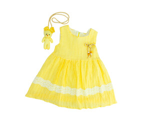 Baby girl yellow dress on white background. Baby clothes in white on white background