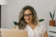 © STUDIO TAURUS - Portrait of adult woman working from home, businesswoman working at home office